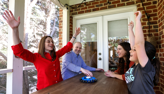 Talia Aron, left, with her family playing a game