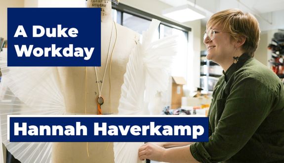 Hannah Haverkamp stands in front of a manikin while working on a costume for an upcoming theater performance.