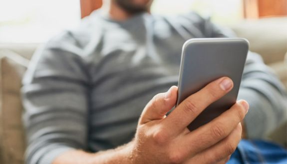Guy holding a phone in his hand