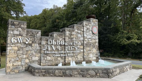 Sign made of stone with Cherokee language on it. 