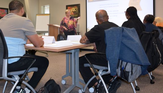 A class listens to the instructor.