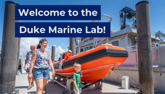 People walking next to a boat at the Marine Lab