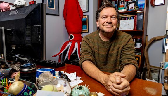 Portrait of Sonke Johnsen sitting at his desk