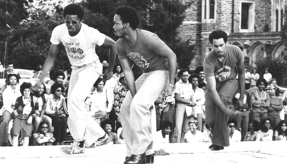 Black and white photo of people dancing in the quad