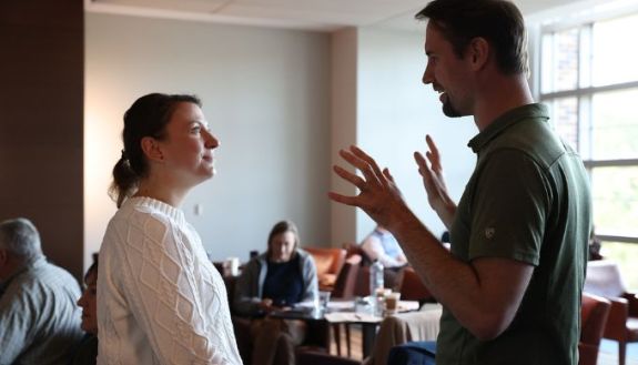Two people having a discussion in a classroom