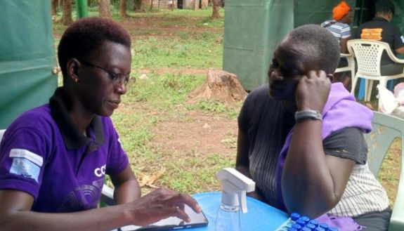 Amelea Atieno, a research assistant with the Center for Global Reproductive Health at Duke, provides cervical cancer screening to a woman attending a health fair in the Gem Sub-County, outside of Kisumu, in Siaya County earlier this year. (Photo submitted by Megan Huchko)