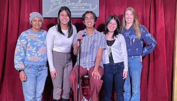 Group of students with one in the middle at a microphone