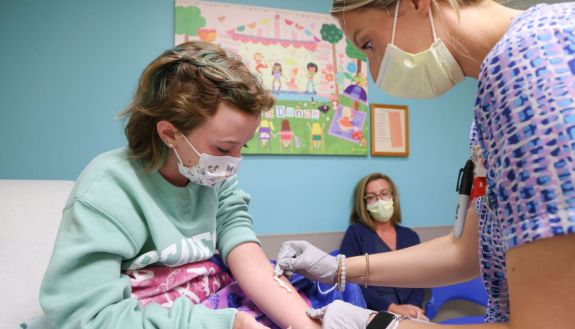 nurse cares for pediatric patient
