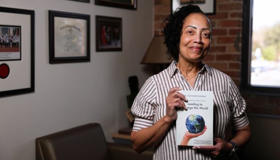 Leslye Kornegay holds her book, "Leading to Change the World"