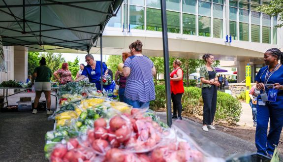 Customers look at fresh produce available at the Duke Farmers Market