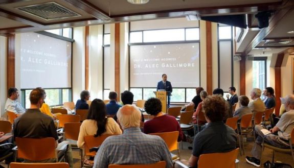 People in a big room listening to a speaker