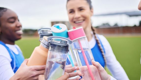 teenagers drinking out of bottles