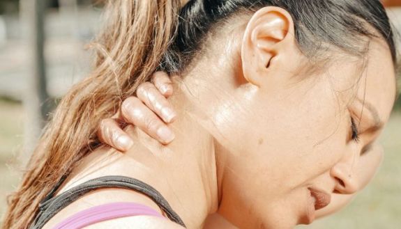 Woman holding her neck in pain