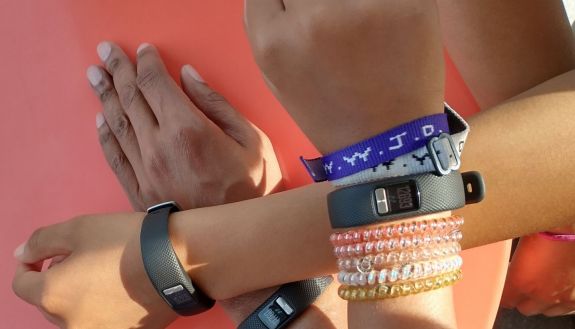 Kids showing Garmin bracelets on their arms