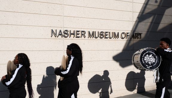 People marching by the sign "nasher museum of art"