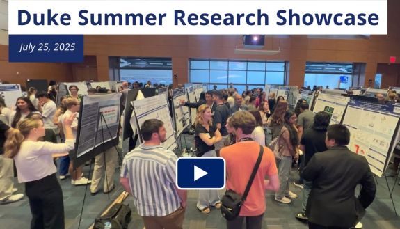 Duke Summer Research Showcase with people milling around posters