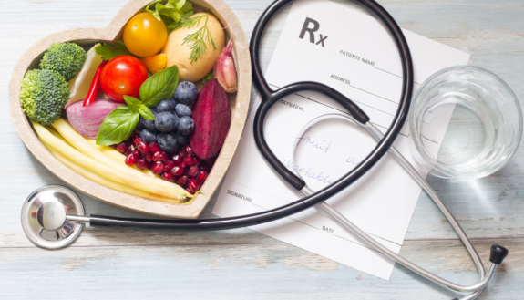 A fruit and vegetable display next to a medical stethoscope