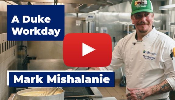 Mark Mishalanie, Executive Chef and Menu Specialist at Duke Dining, stands at the stove.