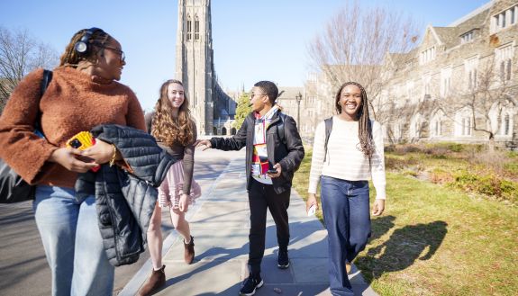 Students greet each other on Abele Quad. 
