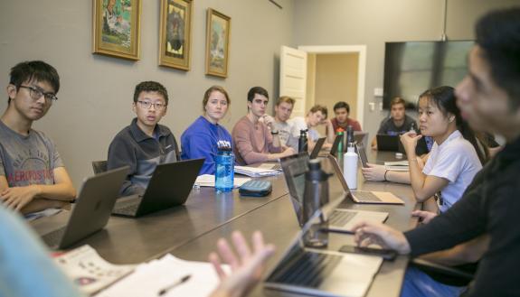 John Rose speaks with his class.