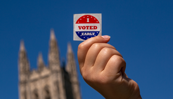 Duke student shows I Voted sticker on Duke's campus