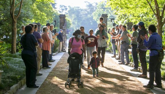 Lined by applauding staff, the first visitors enter through the front gate of Sarah P. Duke Gardens at 8am on the first day of the reopening to the community, Tues. June 1, 2021.
