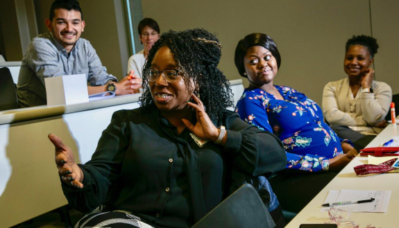 Nadine Barrett, PhD, MS, MA, (far left) engages with students and faculty at a mentor-mentee communications workshop