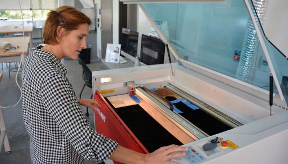 Raquel Salvatella de Prada uses the laser cutter in the Rubenstein Arts Center makerspace to create an art installation. Photo by Jonathan Black.