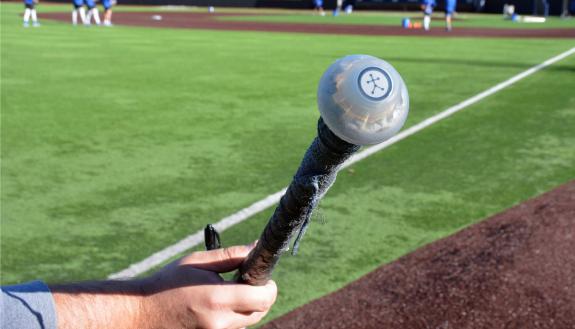 A sensor connected to the handle of a baseball bat helps Duke's baseball coaches learn more about players' swings. Photo by Stephen Schramm.