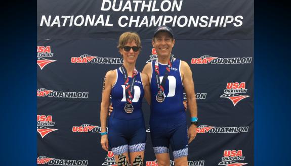 Duke faculty members Rochelle Schwartz-Bloom, left, and Paul Bloom, right, show off their medals at the Duathlon National Championships. Submitted photo.
