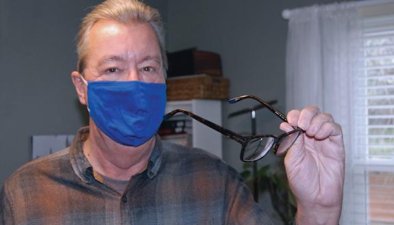 Bob Baldwin shows off computer glasses at his home office in Durham. Photo by Jack Frederick.