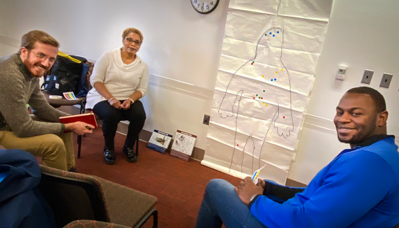 group created a map by tracing their body on a giant sheet of paper. Next, participants imagined a few typical community-engagement scenarios they encounter in their everyday work and applied color-coded dots on the map to pinpoint precisely where in thei