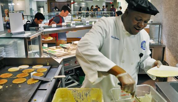 Duke Dining's Wallace Burrows makes pancakes Monday morning in the East Campus Marketplace.
