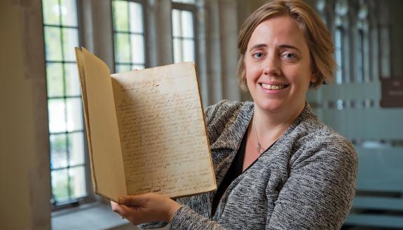 Duke University Archivist Valerie Gillispie holds the constitution of the Union Institute Society. Written in 1839, it is the founding document of the school that later grew into Duke University.