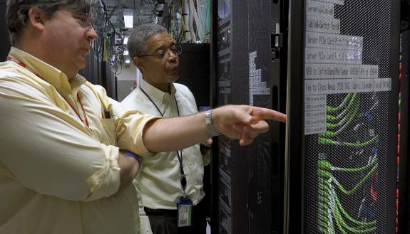 Charley Kneifel, left, with Senior IT Manager, Carl McMillon, in the Duke Data Center in the Telecommunications Building.