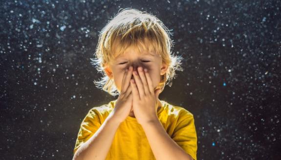 boy sneezing