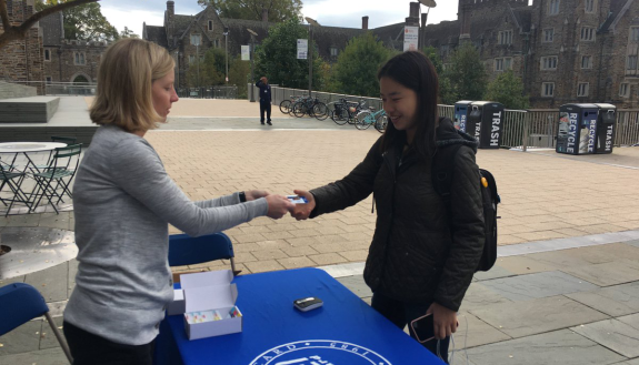 Student Angela Woo is the first to pick up her student voting card, which she can present at the polls today. The POLIS program is coordinating efforts to promote student voting in local elections.