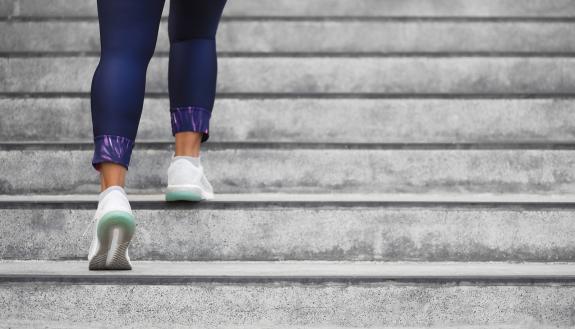 A woman running up stairs.