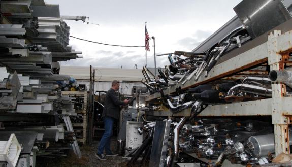 Chip Bobbert, digital media and engineering technologies engineer for Duke’s Office of Information Technology, looks for metal at J & D Recycling. Photo by Stephen Schramm.