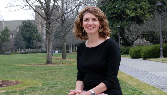 Maria Wisdom, who coaches faculty members and graduate students in her roles at Duke, sits out on the West Campus quad. Photo by Jack Frederick.