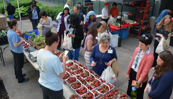 Employees shop for fresh strawberries, bread and empanadas