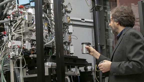 Mario Borgnia loads a sample into the Titan Krios Cryo-EM microscope. (Credit: Megan Mendenhall)