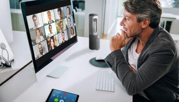 Video meetings with multiple people require more attention to focus on facial expressions and cues than in-person conversations and come with distractions such as noise and virtual background visuals. Photo courtesy of Zoom.