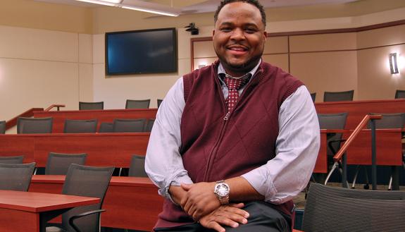 Michael Cary, associate professor at the Duke University School of Nursing, sits in the classroom where he gave his first lecture as a Duke faculty member. Photo by Stephen Schramm.