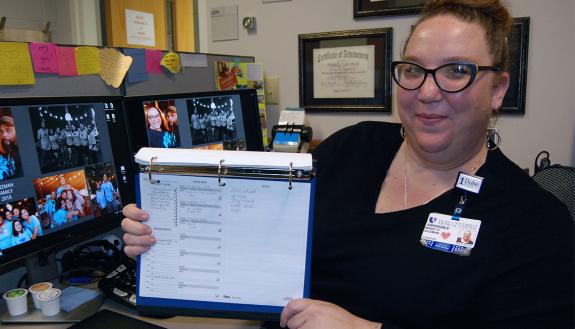 Mindy Guzman, program coordinator with Duke Surgery, shows the list she uses to plan each work day. Photo by Stephen Schramm.