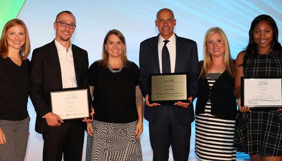 Dawn Hearne, Horton Dining Awards chair, congratulates Duke staff members Marcus Carson, Kirsten Marinko, Robert Coffey, Aris Marton, and Dayla Bonds at the NACUFS ceremony. Photo by Robb Cohen Photography & Video.