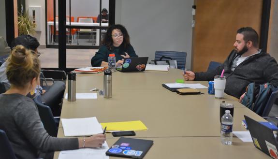 Francesqa Santos, center, a new employee with Duke Student Affairs' Student Involvement team, speaks during a staff meeting. Photo by Jonathan Black.