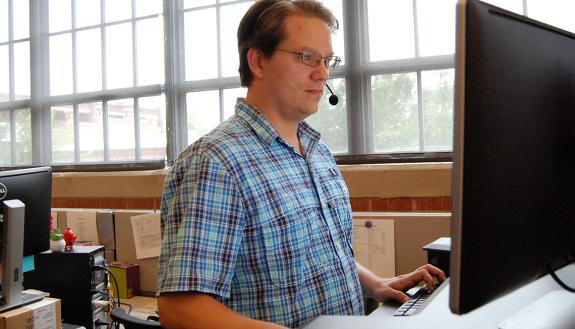 Christian Holder, an IT analyst with the OIT Service Desk, handles a call from customer. Photos by Stephen Schramm.