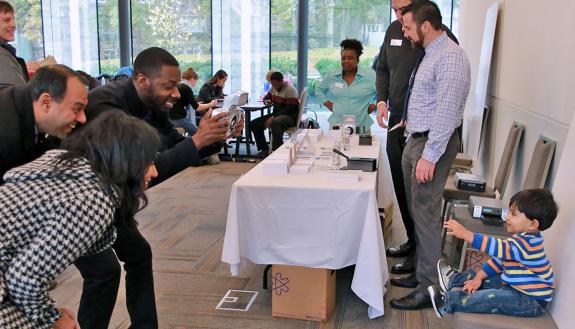 Krishna Udayakumar, left, watches his son have his passport taken at last year's Duke Passport Drive. Photo courtesy of the Duke Office for Global Affairs.