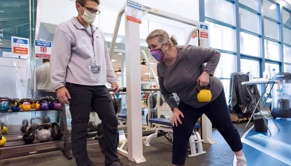 A personal trainer works with one of the members of the Duke Health and Fitness Center. Photo courtesy of the Duke Health and Fitness Center.